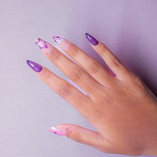 Soul Struck purple press-on nails with  white floral accent nail art, featuring a reusable almond-shaped salon-style manicure.3