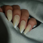 Soul Struck Milky white almond press-on nails with a subtle iridescent shimmer, reusable glue-on nails for a salon-quality manicure and elegant everyday look.
