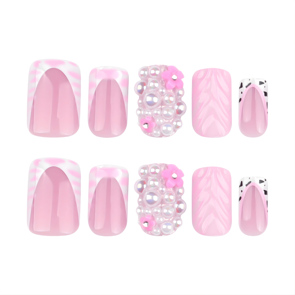 Soul Struck pink press-on nails with pearl embellishments, abstract swirl nail art, French tips, and black accent detailing, featuring a reusable square-shaped salon-style manicure. 3