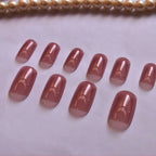 Dusty rose nude press-on nails featuring a translucent jelly effect, glossy reusable glue-on nails for everyday wear.