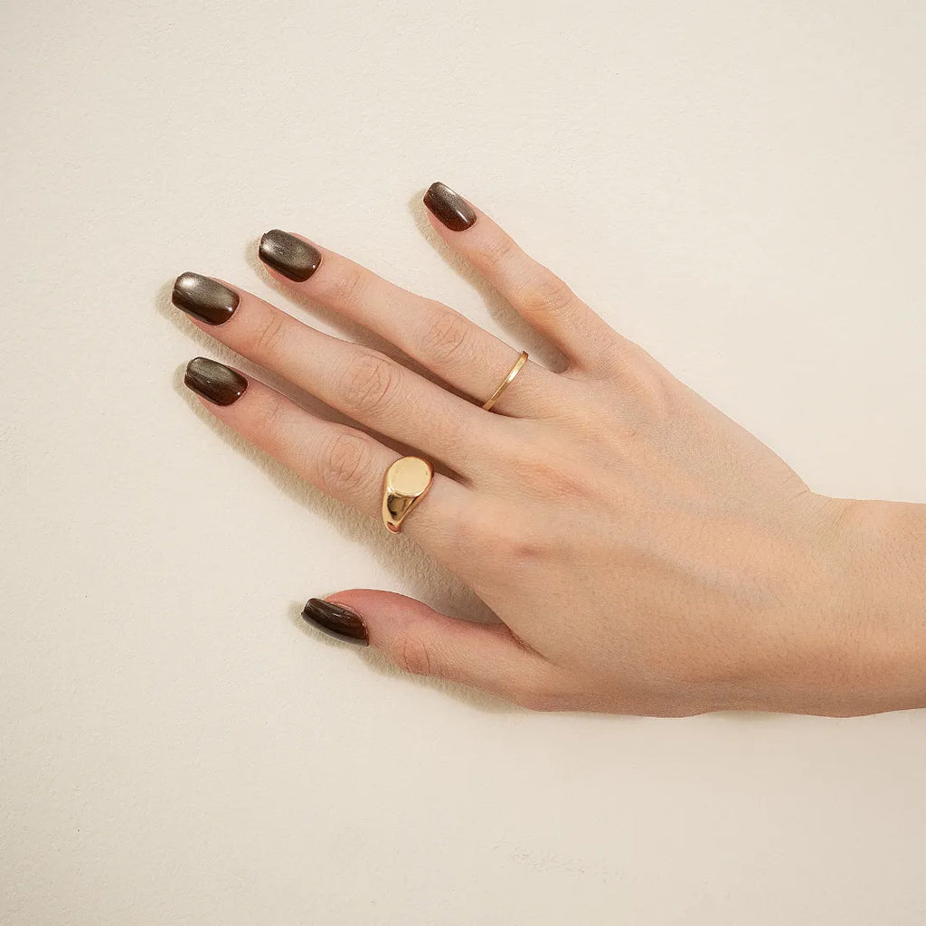 Metallic bronze chrome press-on nails with glossy finish in a medium square-oval shape