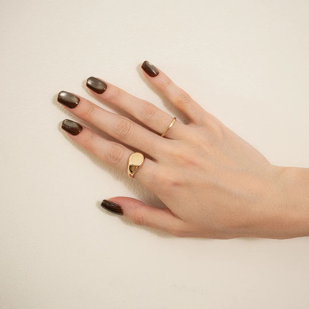 Metallic bronze chrome press-on nails with glossy finish in a medium square-oval shape