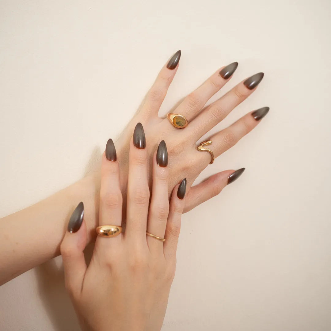 Long almond-shaped brown ombré press-on nails with a glossy gradient finish
