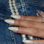 Pearl white shimmer press-on nails in a medium almond shape, reusable false nails with a glossy salon-quality finish.