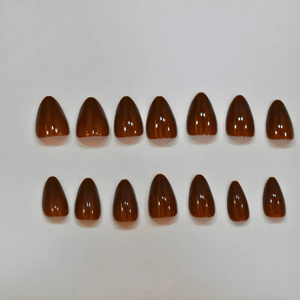 Chocolate brown almond press-on nails with glossy finish, reusable fake nails for a professional salon manicure.