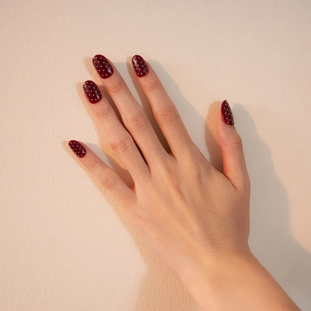crimson shade short press-on nails with white polka dots by Soul Struck