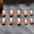 Rose gold chrome press-on nails with a glossy metallic finish in a short square shape, reusable glue-on nails for a salon-quality manicure.