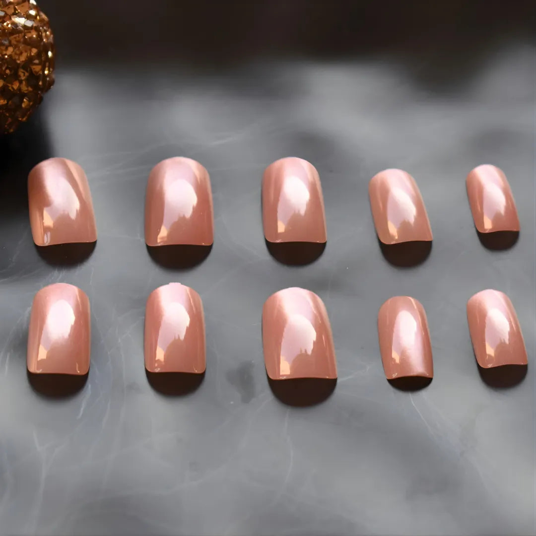 Rose gold chrome press-on nails with a glossy metallic finish in a short square shape, reusable glue-on nails for a salon-quality manicure.