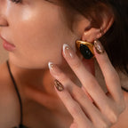 Premium nude chrome abstract press-on nails with metallic gold swirl accents, rhinestone details, and glossy almond shape by Soul Struck