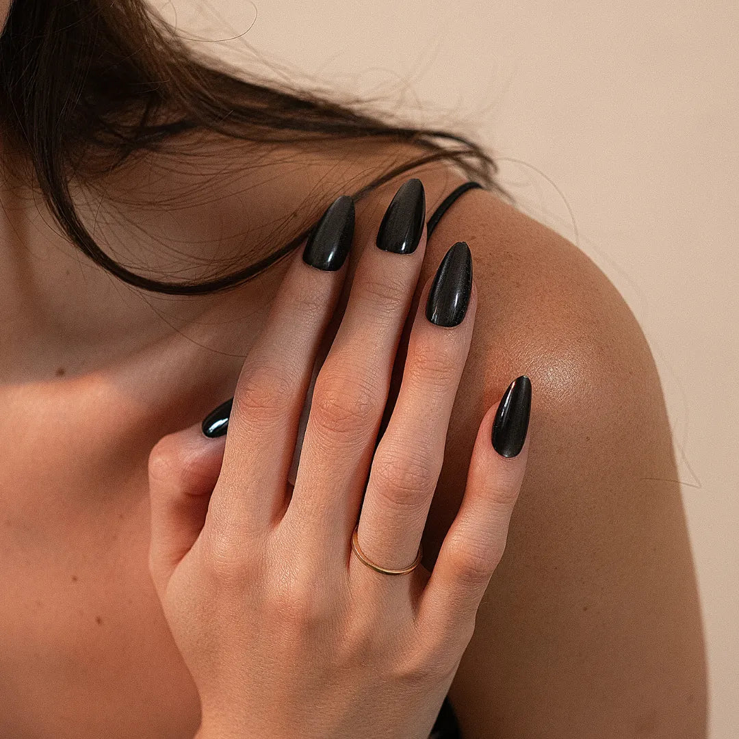 "Soul Struck Premium matte black cat eye press-on nails in a long almond shape with a metallic shimmer finish for a bold, salon-quality look."