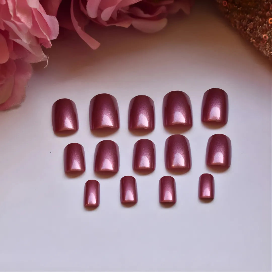 Luxury rose pink chrome press-on nails with a reflective metallic finish and square shape for an elegant manicure.