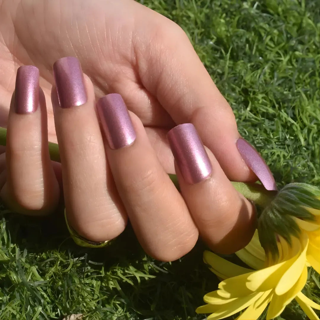 Glossy metallic pink chrome press-on nails with a medium square shape, reusable false nails for a salon-quality manicure.