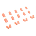 Terracotta orange press-on nails in square shape, glossy reusable fake nails with professional salon look.