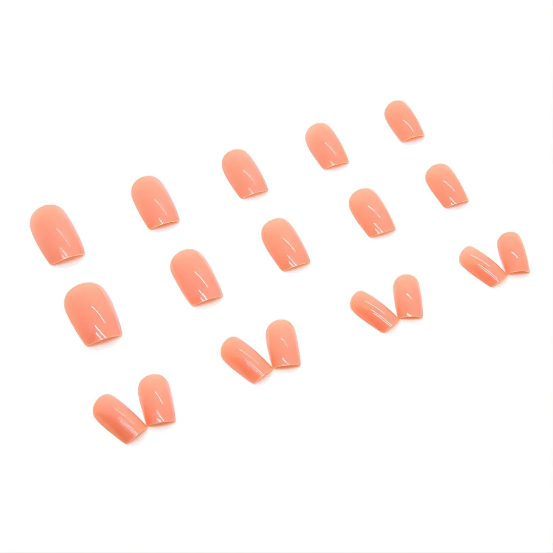 Terracotta orange press-on nails in square shape, glossy reusable fake nails with professional salon look.