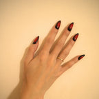 Long almond-shaped black and deep red ombré press-on nails with a glossy gradient finish